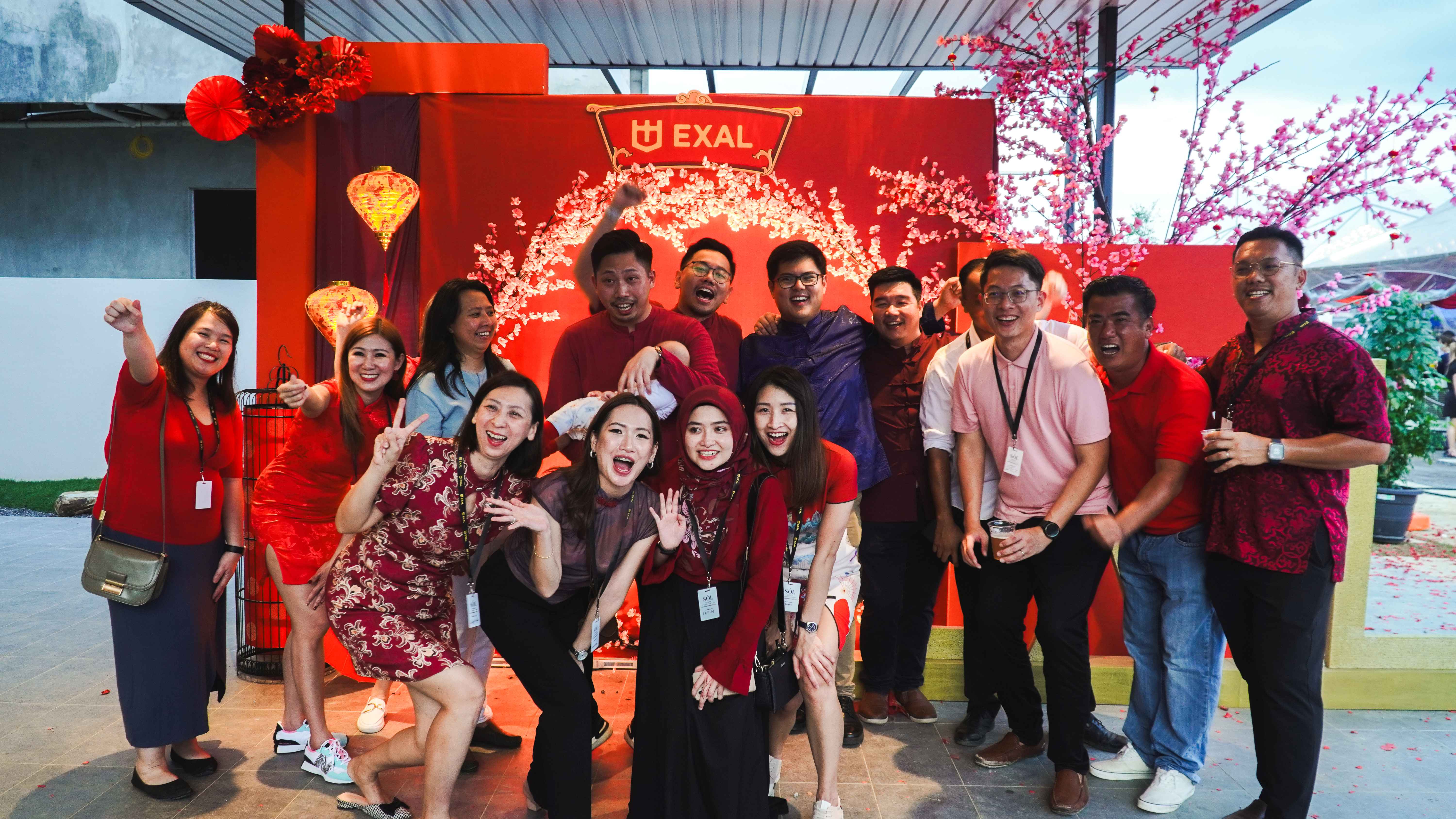 A large EXAL team celebrating together at a company gathering